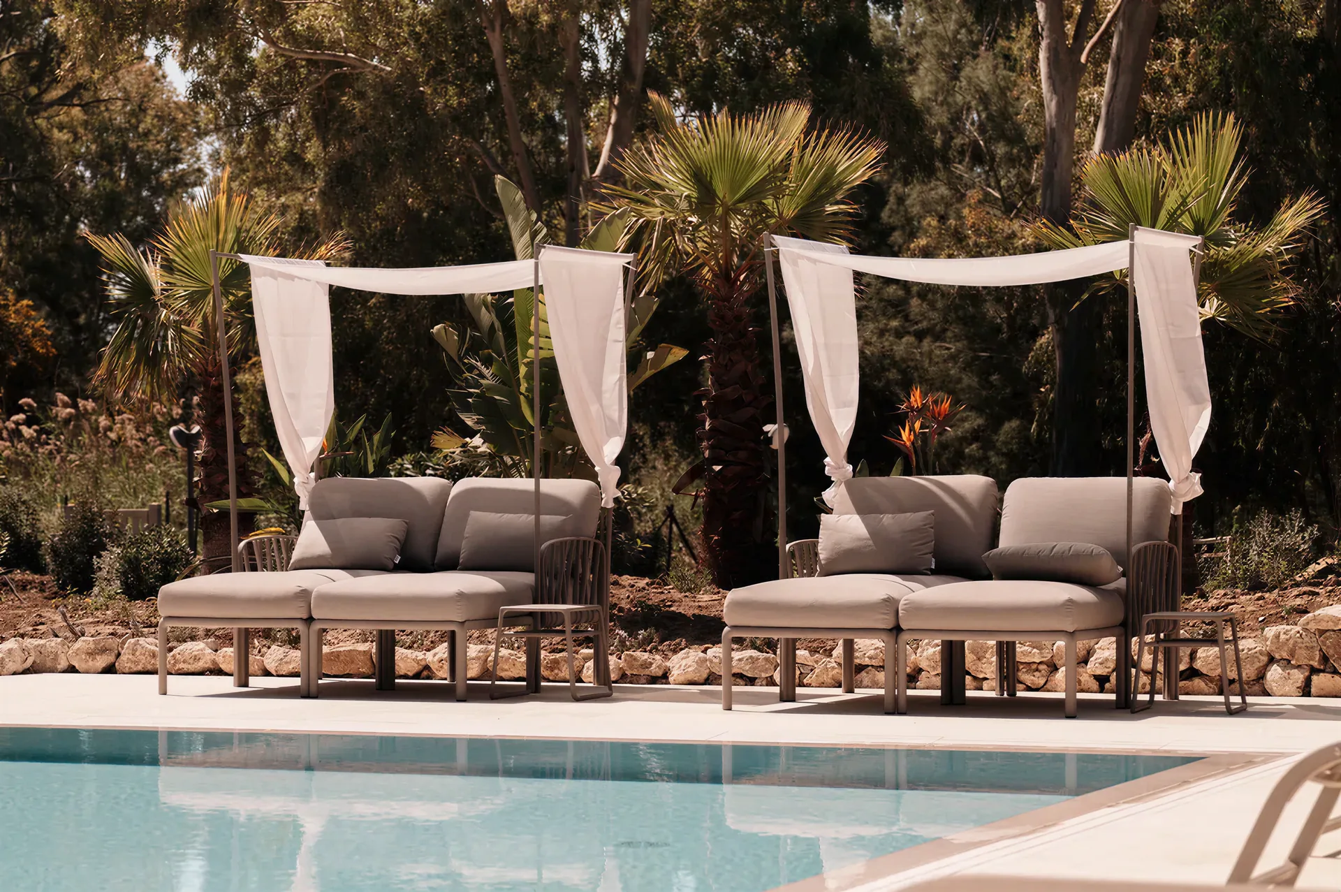 Nardi sun loungers and canopy daybeds by the pool